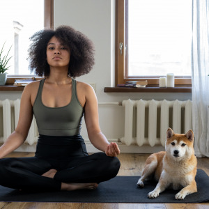 Woman and dog doing yoga